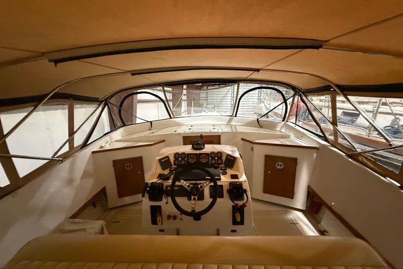 Slide: The Image of Interior view of a 1979 Magnum 38 Sport boat cockpit with steering wheel and controls. - 27