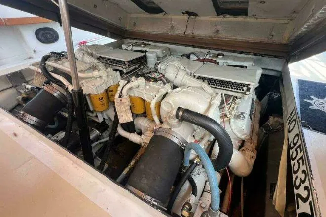 Slide: The Image of Engine compartment of a 1979 Magnum 38 Sport boat, showcasing dual engines. - 53
