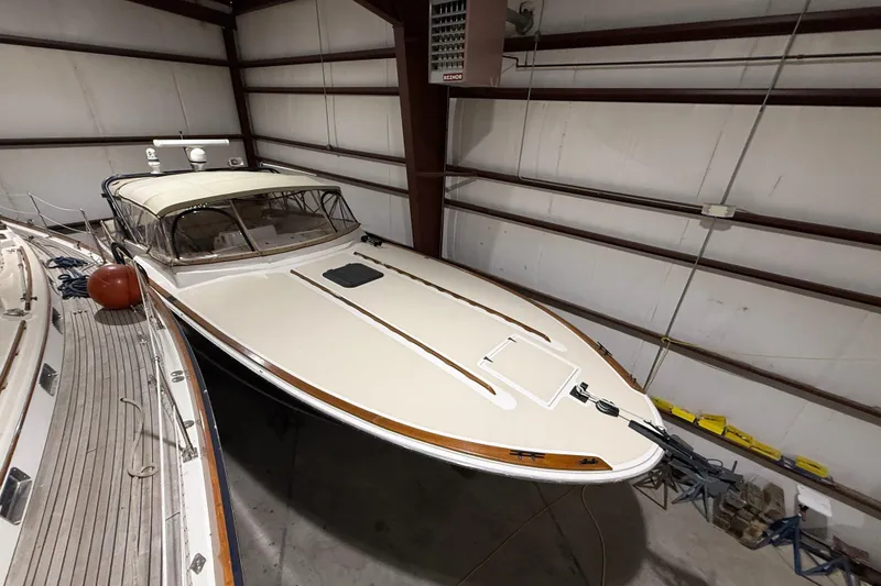 Slide: The Image of 1979 Magnum 38 Sport boat in storage, showcasing sleek design and classic features. - 5