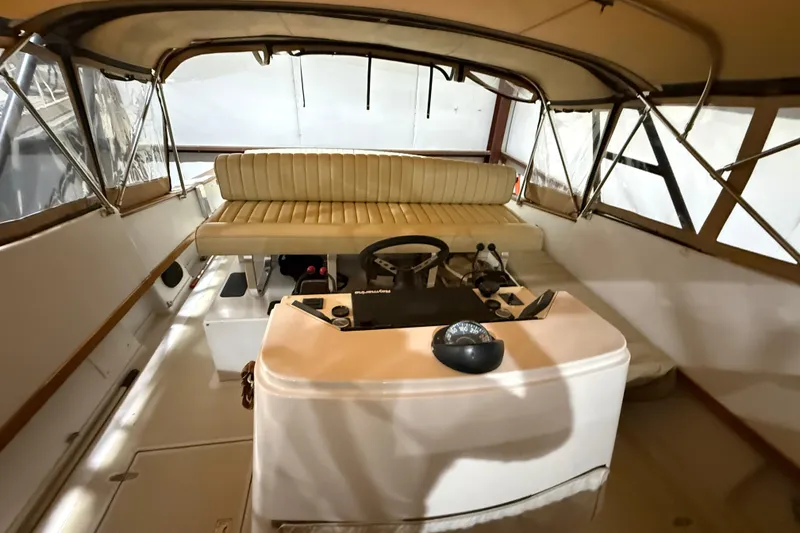 Slide: The Image of Interior of a 1979 Magnum 38 Sport boat with beige seating and steering console. - 29