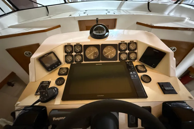 Slide: The Image of Cockpit of a 1979 Magnum 38 Sport boat with navigation instruments and controls. - 31