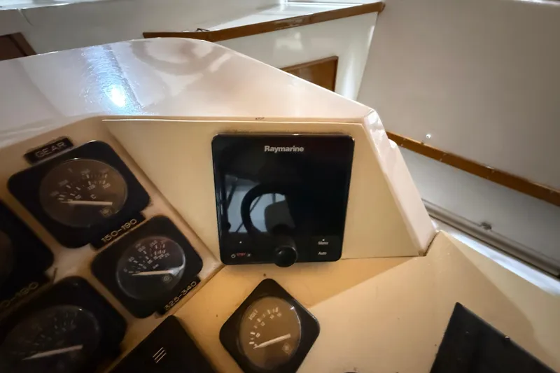 Slide: The Image of Control panel of a 1979 Magnum 38 Sport boat with Raymarine display. - 33