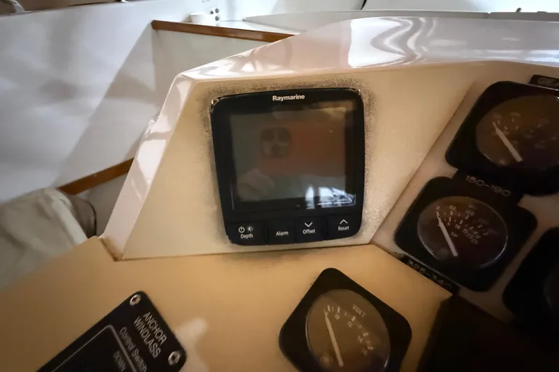 Slide: The Image of Control panel of a 1979 Magnum 38 Sport boat with Raymarine display and gauges. - 34