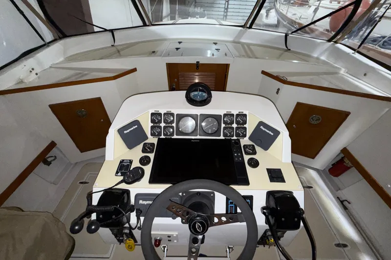Slide: The Image of Cockpit of a 1979 Magnum 38 Sport boat with steering wheel and navigation instruments. - 37