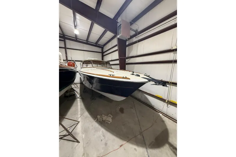 Slide: The Image of 1979 Magnum 38 Sport boat stored indoors, showcasing sleek design and classic style. - 6