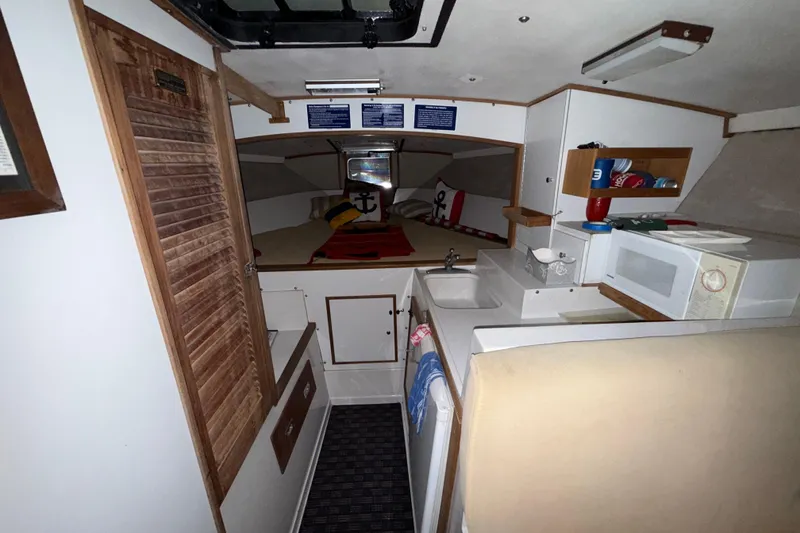Slide: The Image of Interior of a 1979 Magnum 38 Sport boat with kitchenette and cozy sleeping area. - 40