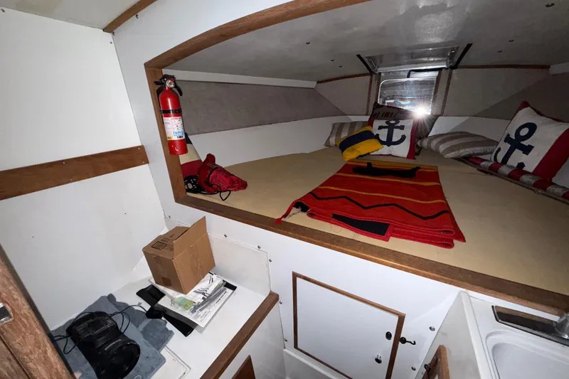 Slide: The Image of Interior of a 1979 Magnum 38 Sport boat with cozy bedding and nautical decor. - 43