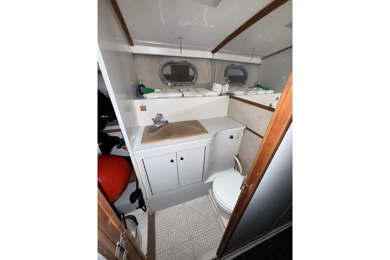 Slide: The Image of Bathroom interior of a 1979 Magnum 38 Sport boat with sink and toilet. - 46