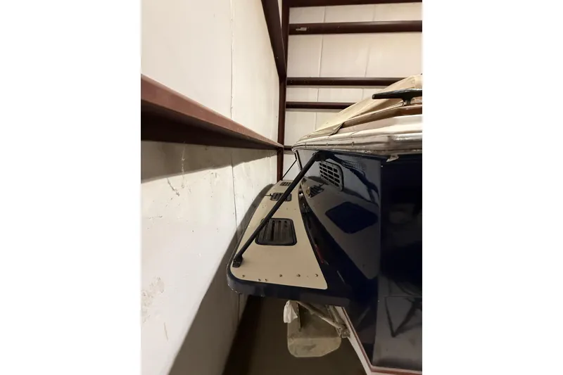 Slide: The Image of 1979 Magnum 38 Sport boat stored indoors, showcasing sleek design and detailing. - 48