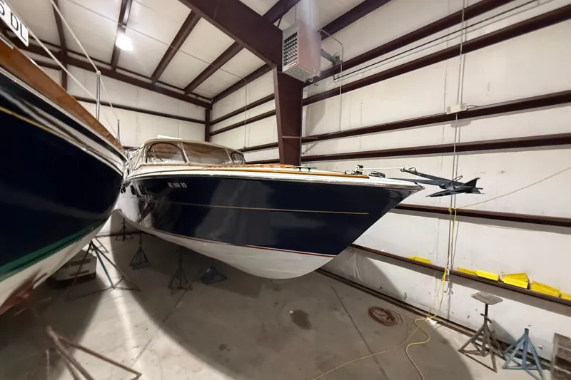 Slide: The Image of 1979 Magnum 38 Sport boat stored indoors, showcasing sleek design and classic style. - 7