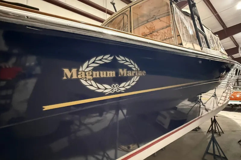 Slide: The Image of 1979 Magnum 38 Sport boat in a warehouse, showcasing "Magnum Marine" logo. - 49