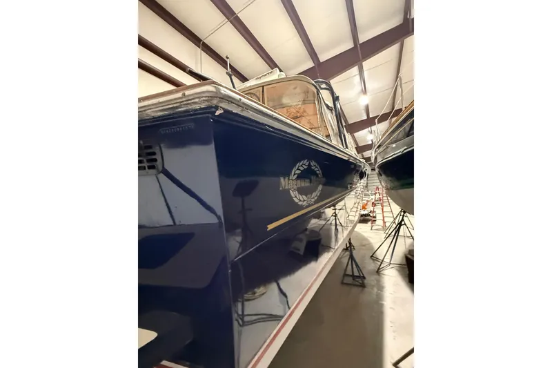 Slide: The Image of 1979 Magnum 38 Sport boat in storage, blue hull, indoor facility. - 50