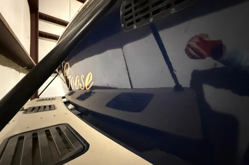Slide: The Image of 1979 Magnum 38 Sport boat with "Goose" name, reflecting in a garage setting. - 52