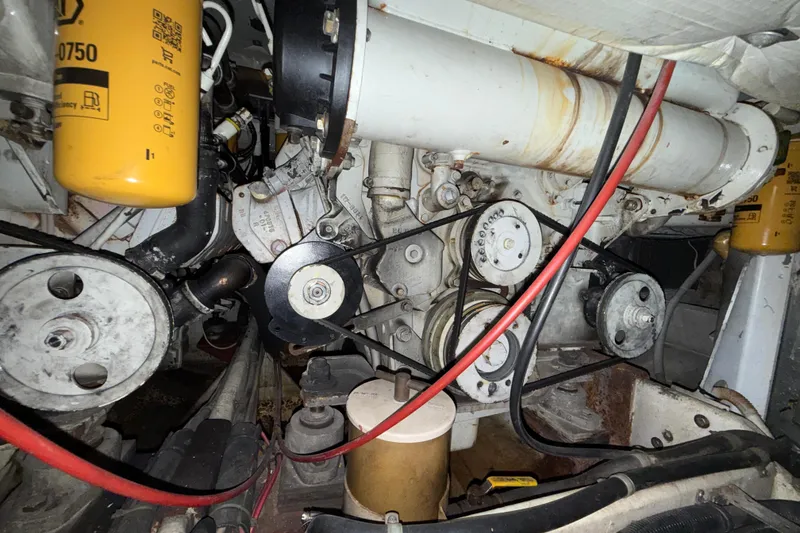 Slide: The Image of Engine compartment of a 1979 Magnum 38 Sport boat, showcasing belts and filters. - 54