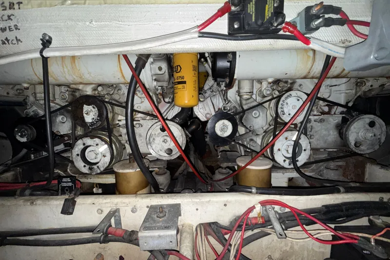 Slide: The Image of Engine compartment of a 1979 Magnum 38 Sport with visible belts and wiring. - 56