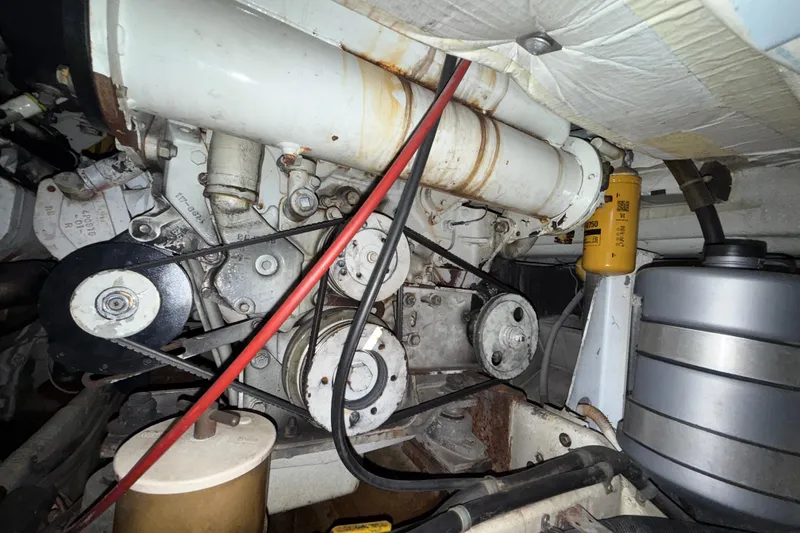 Slide: The Image of Engine compartment of a 1979 Magnum 38 Sport boat, showcasing belts and components. - 57