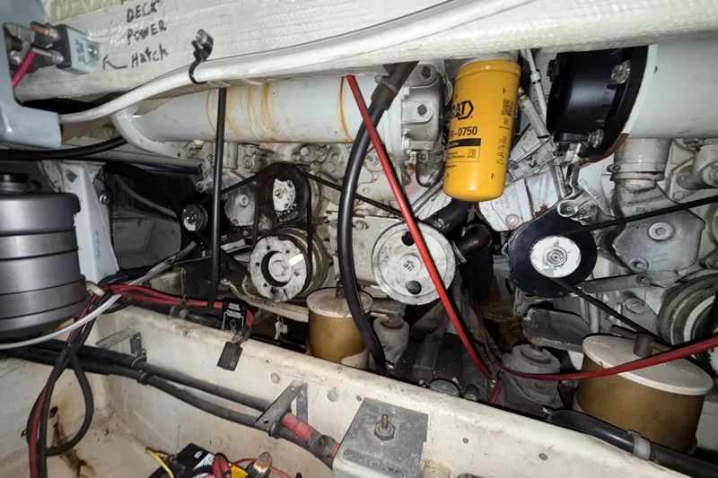 Slide: The Image of Engine compartment of a 1979 Magnum 38 Sport boat, showcasing mechanical components and wiring. - 58