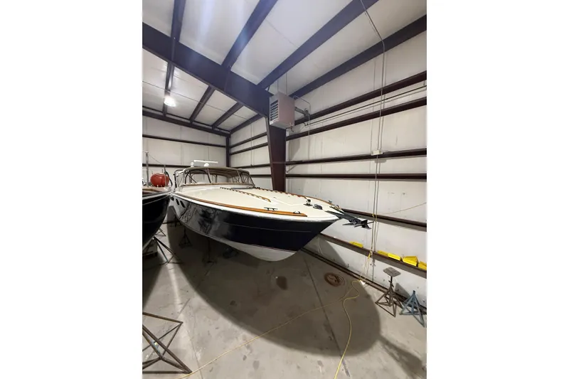 Slide: The Image of 1979 Magnum 38 Sport boat stored indoors, showcasing sleek design and classic style. - 8