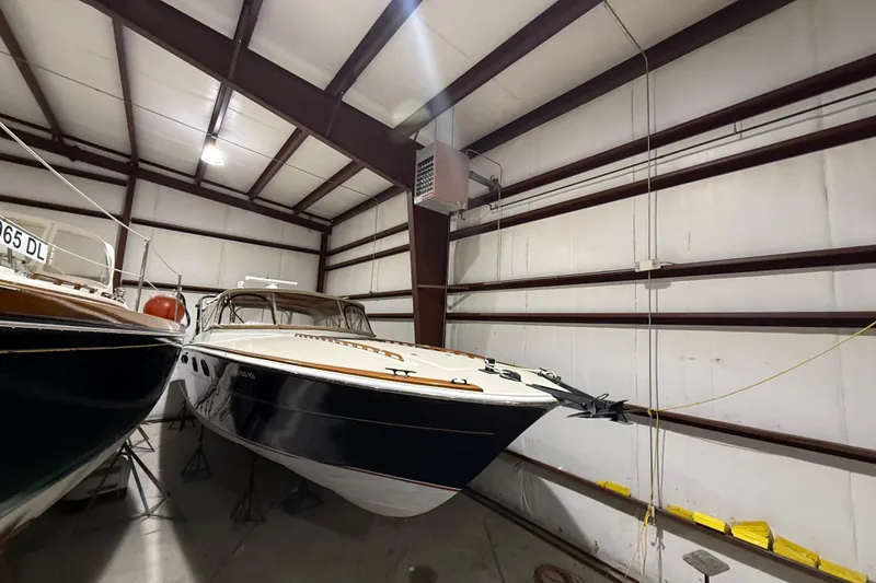 Slide: The Image of 1979 Magnum 38 Sport boat stored indoors, showcasing sleek design and classic style. - 9