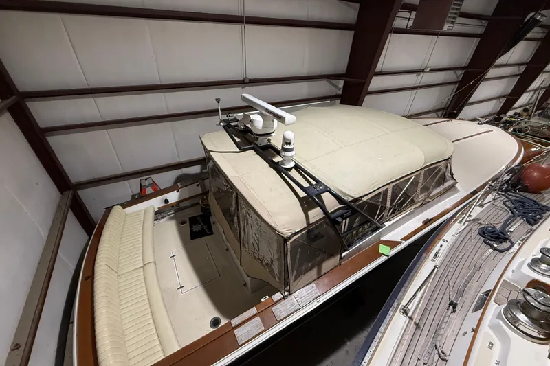 Slide: The Image of 1979 Magnum 38 Sport boat in storage, featuring a covered deck and classic design. - 10