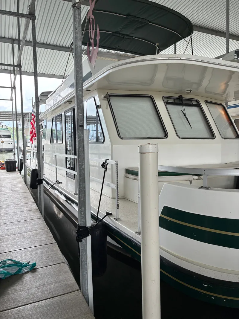 Slide: The Image of 1993 Gibson 50 houseboat docked in marina. - 1