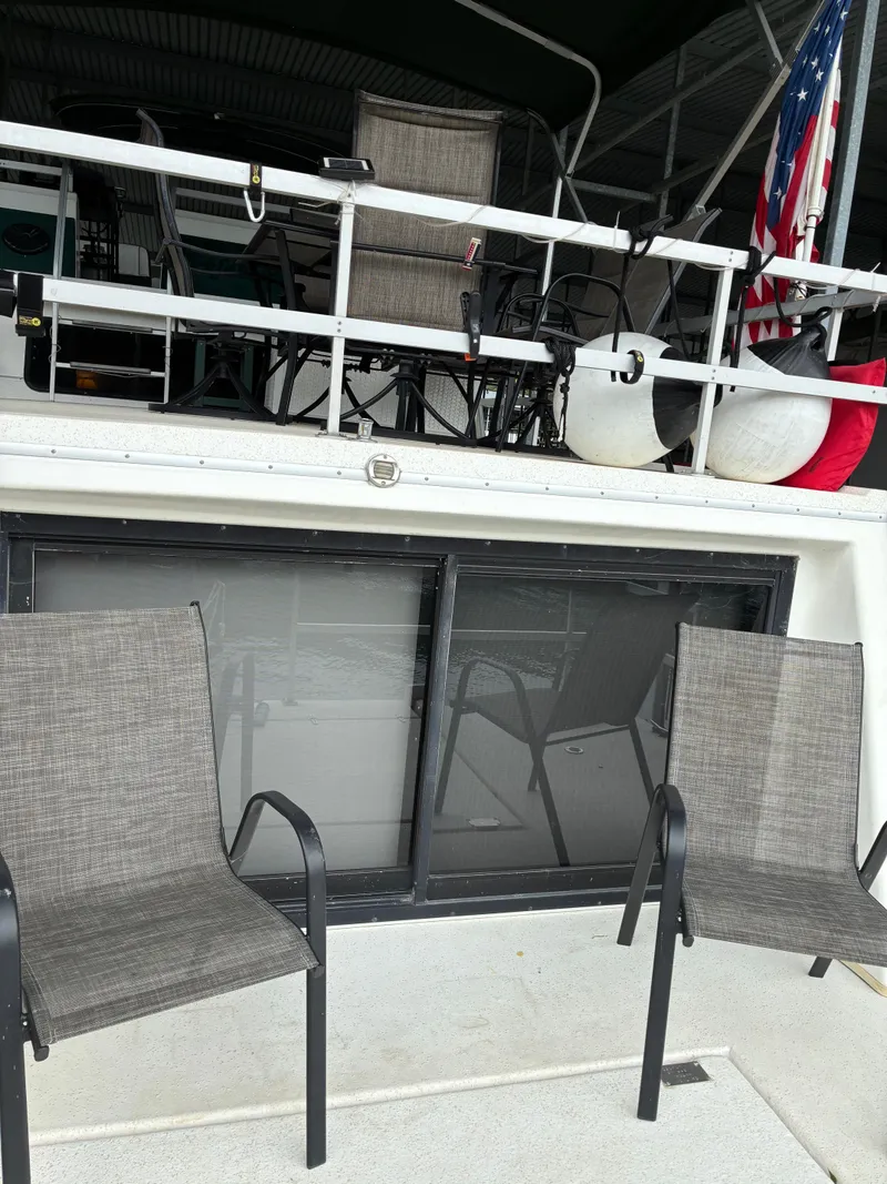 Slide: The Image of 1993 Gibson 50 boat with chairs and flag. - 4
