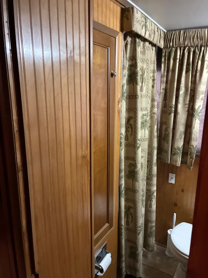 Slide: The Image of Wood-paneled bathroom in a 1993 Gibson 50 boat. - 9
