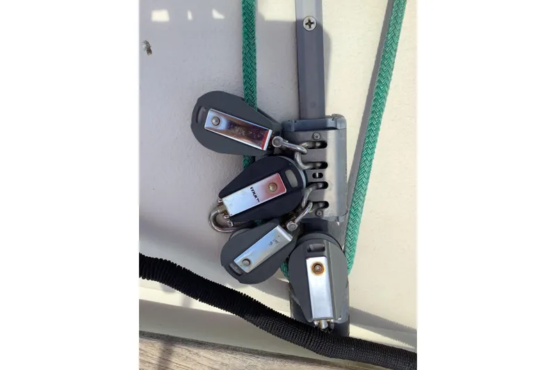 Slide: The Image of Close-up of a 1994 Caliber Cutter Rig sailboat's pulley system with green rope. - 20