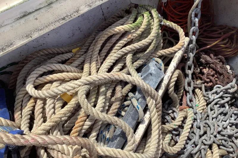 Slide: The Image of Tangled ropes and chains on a 1994 Caliber Cutter Rig sailboat deck. - 23