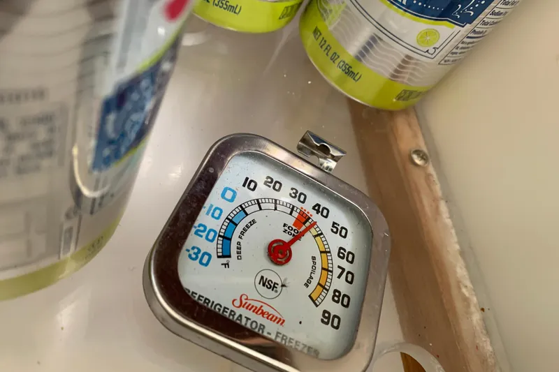 Slide: The Image of Refrigerator thermometer reading near canned drinks, Sunbeam brand, NSF certified. - 33