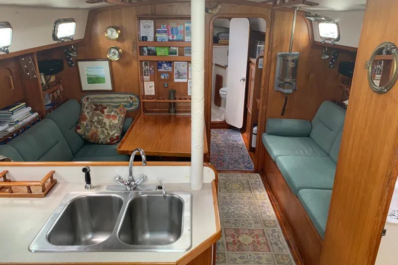 Slide: The Image of Interior of 1994 Caliber Cutter Rig sailboat with cozy seating and kitchen area. - 36