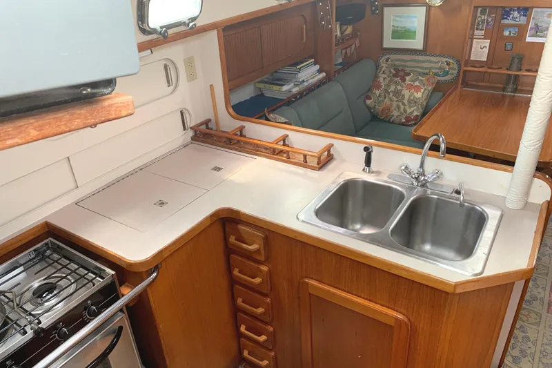 Slide: The Image of Interior of a yacht kitchen with sink, stove, and seating area. - 37