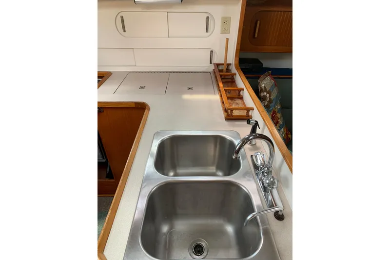 Slide: The Image of 1994 Caliber Cutter Rig kitchen with dual sinks and wooden accents. - 39