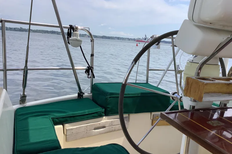 Slide: The Image of Cockpit of 1994 Caliber Cutter Rig sailboat with green cushions and steering wheel. - 4