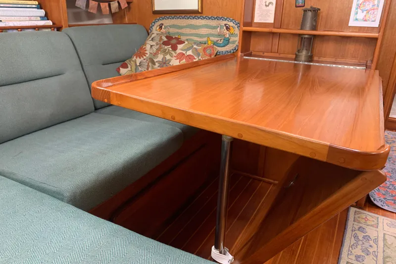 Slide: The Image of Expandable wooden table and green seating. - 42