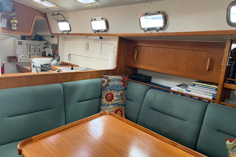 Slide: The Image of Interior of 1994 Caliber Cutter Rig sailboat with cozy seating and wooden cabinetry. - 43
