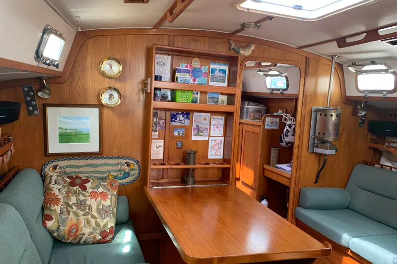 Slide: The Image of Interior of 1994 Caliber Cutter Rig sailboat with wooden furnishings and cozy seating area. - 44