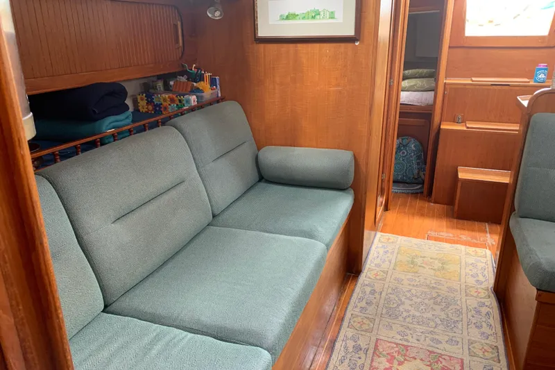 Slide: The Image of Interior of 1994 Caliber Cutter Rig sailboat with cozy seating and wooden finishes. - 46