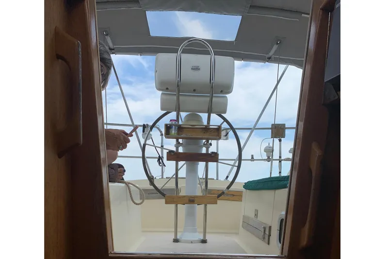 Slide: The Image of Interior view of a 1994 Caliber Cutter Rig sailboat cockpit with steering wheel. - 47