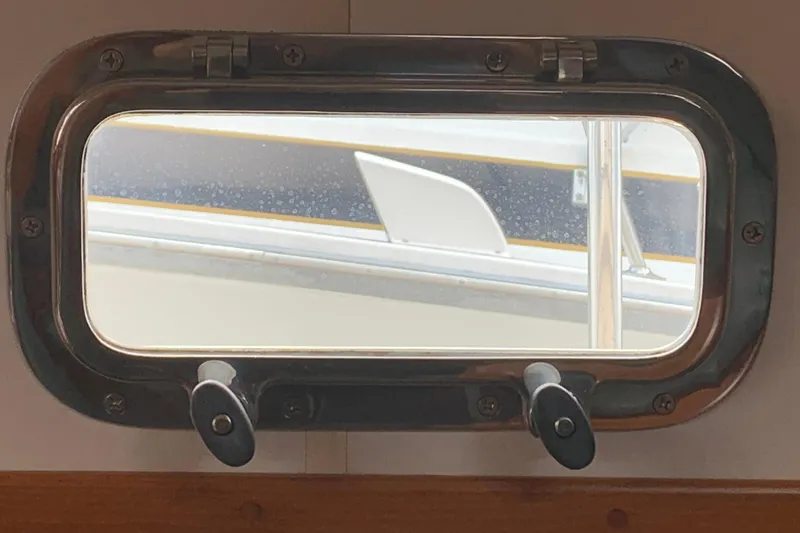 Slide: The Image of Porthole view from 1994 Caliber Cutter Rig sailboat, showcasing exterior details. - 51
