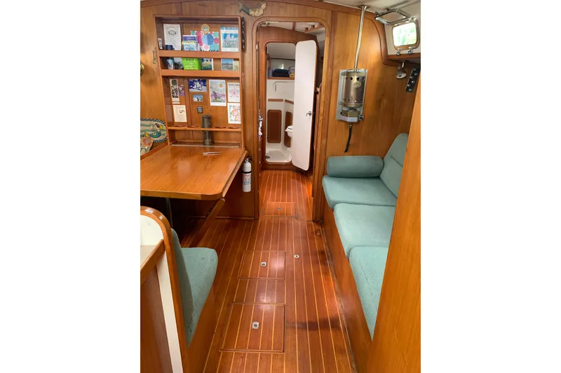 Slide: The Image of Interior of 1994 Caliber Cutter Rig sailboat with wooden flooring and cozy seating area. - 58
