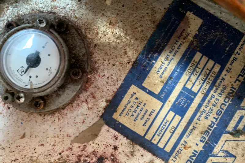 Slide: The Image of Gauge and label on a 1994 Caliber Cutter Rig, showing wear and dirt. - 69