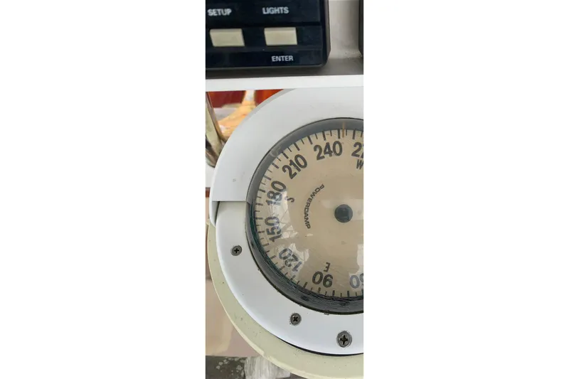 Slide: The Image of Close-up of a 1994 Caliber Cutter Rig compass and control panel. - 81