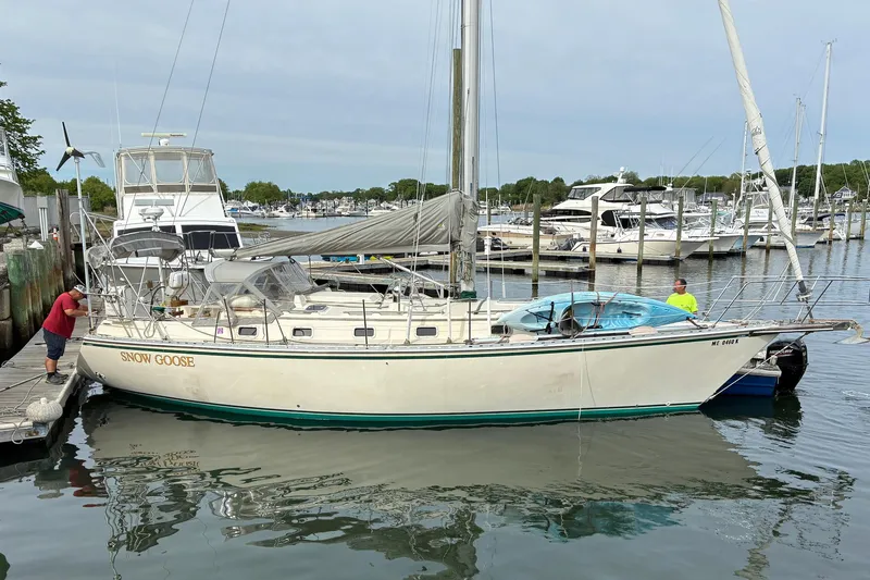 Slide: The Image of 1994 Caliber Cutter Rig sailboat "Snow Goose" docked at a marina. - 83
