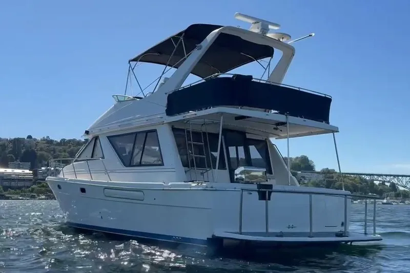 Slide: The Image of 1997 Bayliner 3988 Command Bridge Motoryacht on water, showcasing sleek design and spacious deck. - 1