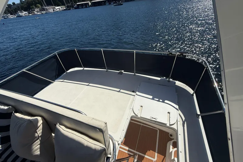 Slide: The Image of 1997 Bayliner 3988 Command Bridge Motoryacht deck overlooking serene marina waters. - 12