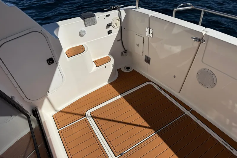Slide: The Image of 1997 Bayliner 3988 Command Bridge Motoryacht deck with teak flooring, overlooking the ocean. - 15