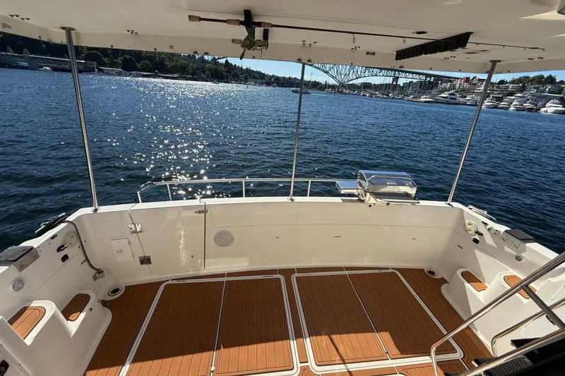 Slide: The Image of 1997 Bayliner 3988 Command Bridge Motoryacht deck overlooking sparkling water and marina. - 16