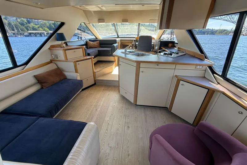 Slide: The Image of Interior of 1997 Bayliner 3988 Command Bridge Motoryacht with spacious seating and kitchen area. - 17