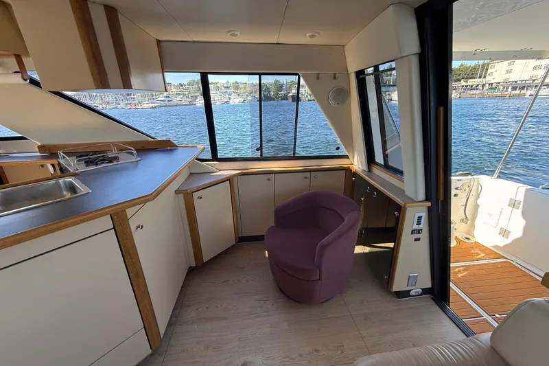 Slide: The Image of Interior of 1997 Bayliner 3988 Command Bridge Motoryacht with waterfront view and modern furnishings. - 18